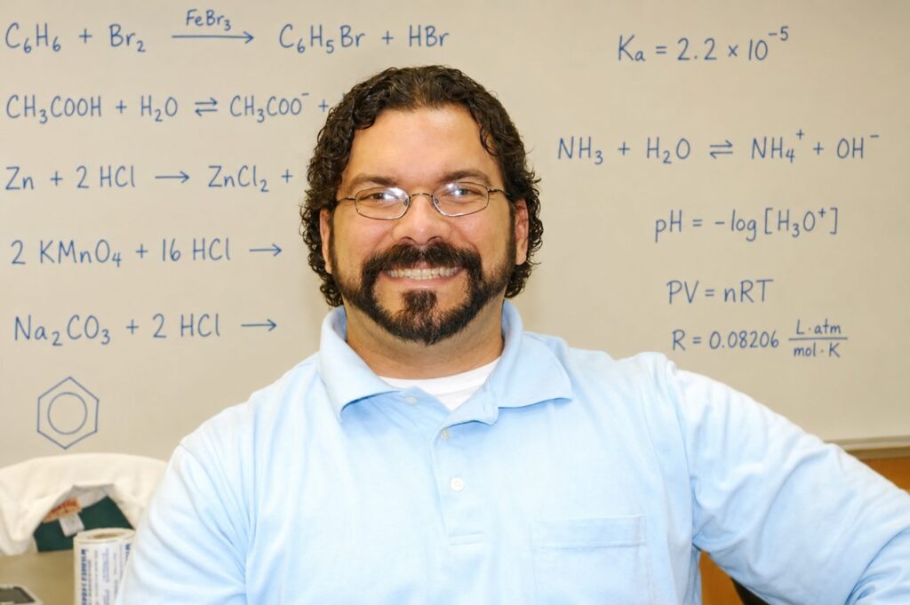 Jorge Camacho, AP Chemistry teacher and founder of Virtually There Teaching, standing in front of a whiteboard